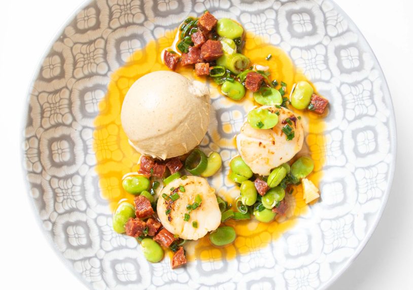 Pan-fried scallops with cumin-spiced cauliflower pannacotta, warm broad bean & chorizo vinaigrette, £16.