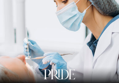 Dental professional wearing protective equipment while treating a patient