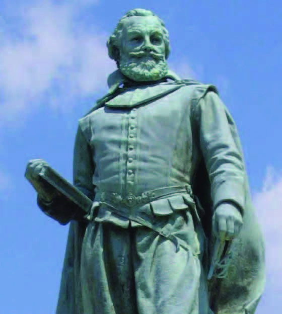 Statue of Lincolnshire explorer Captain John Smith against a blue sky.