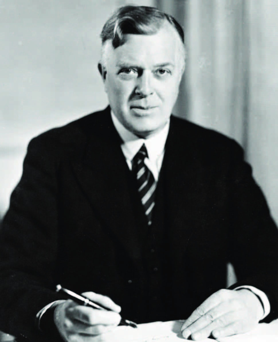 Black-and-white desk portrait of transport design pioneer Frank Pick.