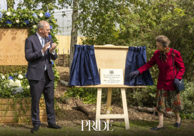 The Princess Royal unveils a plaque beside a wooden easel at the University of Lincoln's Riseholme Campus as Vice-Chancellor Neal Juster applauds