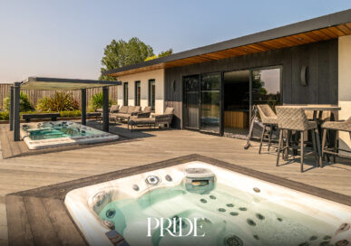 Pool house at Eastview, Skegness, with a sunken hot tub, decking, outdoor seating and a glazed outdoor kitchen