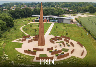 Aerial view of the International Bomber Command Centre in Lincoln, showing the tall Spire surrounded by the curved Walls of Names and the visitor centre