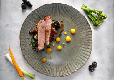 Pan roasted Barbary duck breast with pumpkin purée, fondant potato, purple kale, roasted fig & blackberry jus.