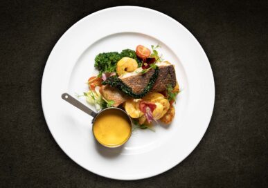 Poisson Du Jour with Crevette bouillabaisse velouté, buttered kale, sautéed new potatoes, £25.