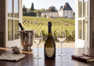 Bottle of Dom Perignon champagne with a vineyard view