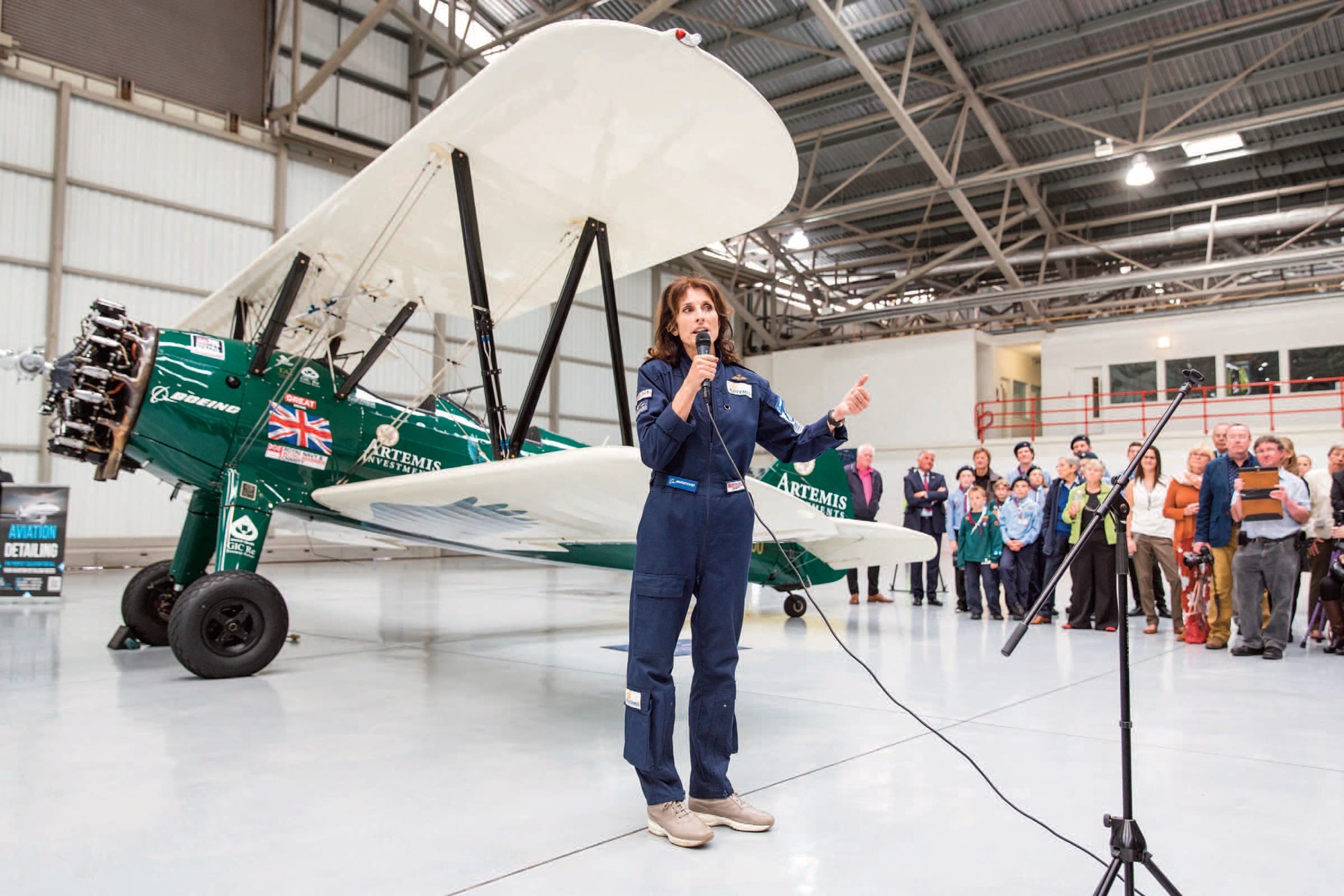 Tracey Curtis-Taylor, Stamford-born aviator beside a vintage aircraft