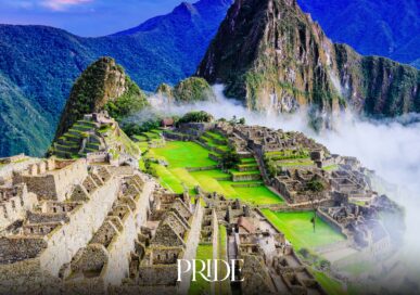Machu Picchu, the Inca citadel in Peru, seen at dawn through mist with mountains behind