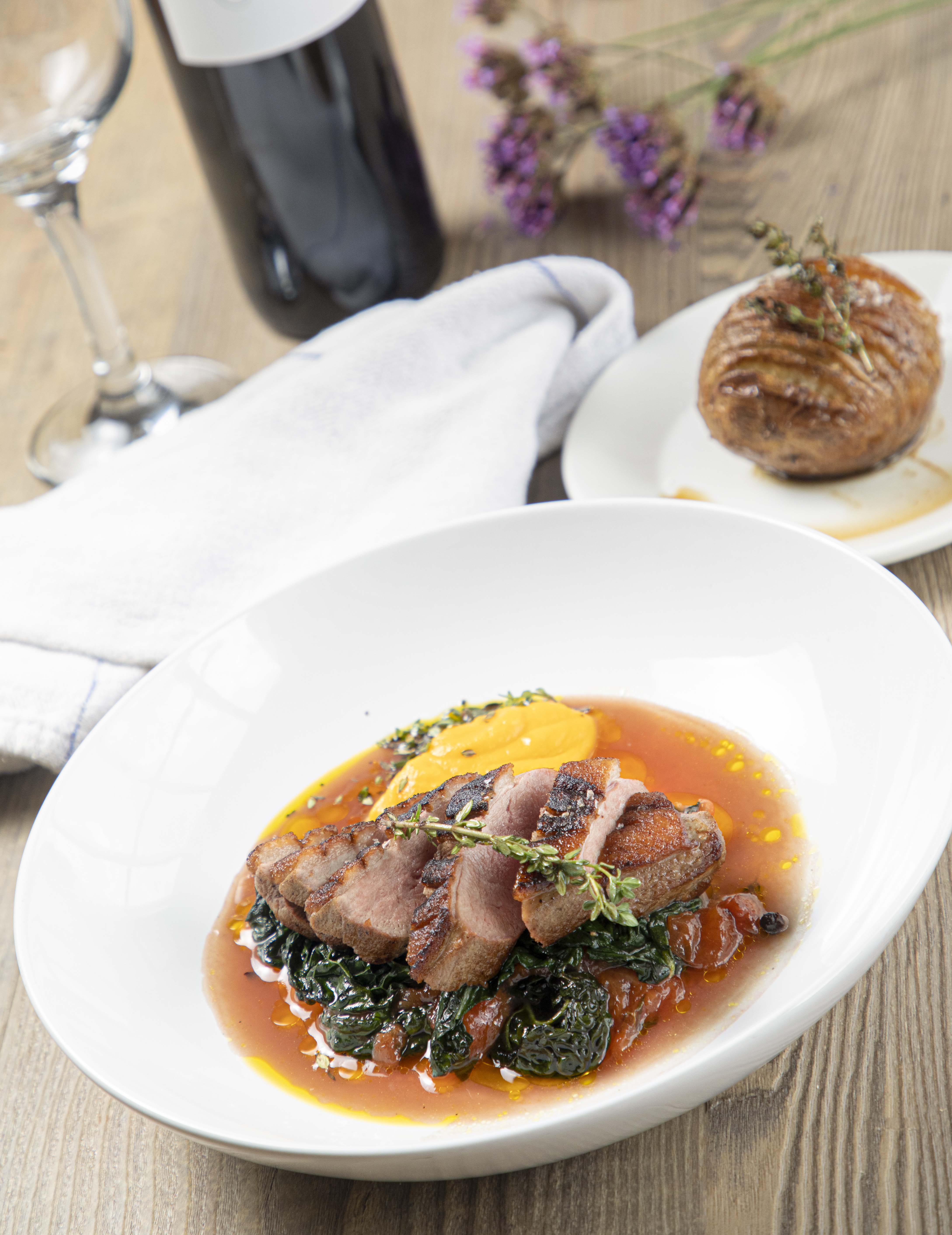 Pan seared duck with warm plum chutney, root vegetable purée, cavolo nero cale and hasselback potatoes at The Exeter Arms, Barrowden.